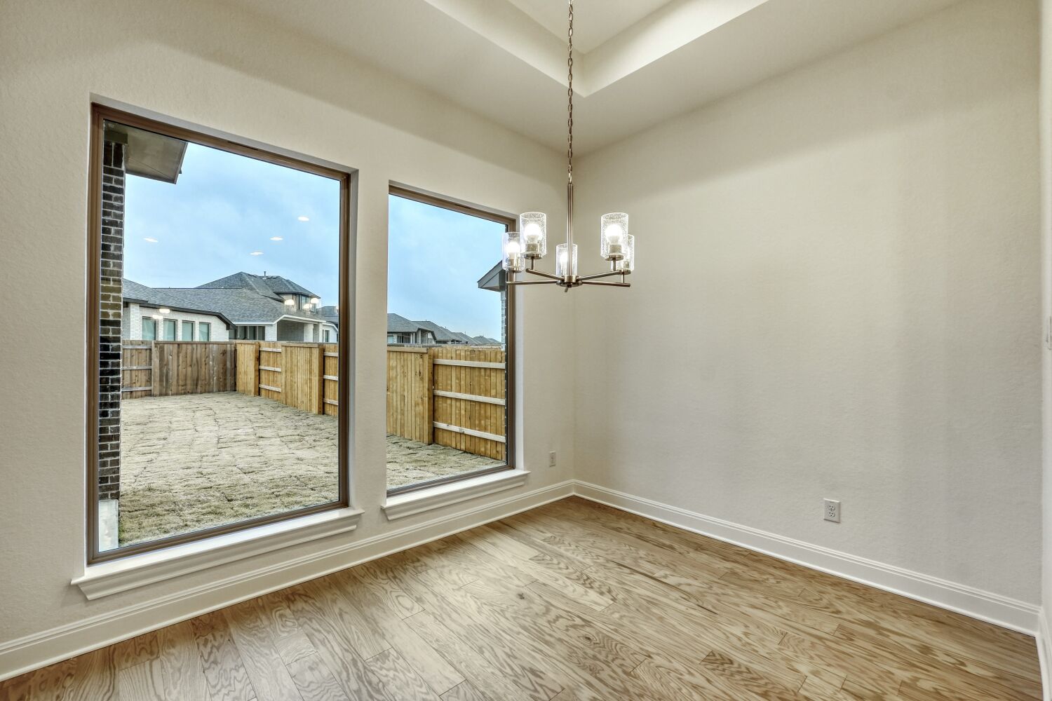 253 Prickly Poppy Loop Kyle, TX 78640 - Photo 6 of 11 an empty room with wooden floor fan and windows