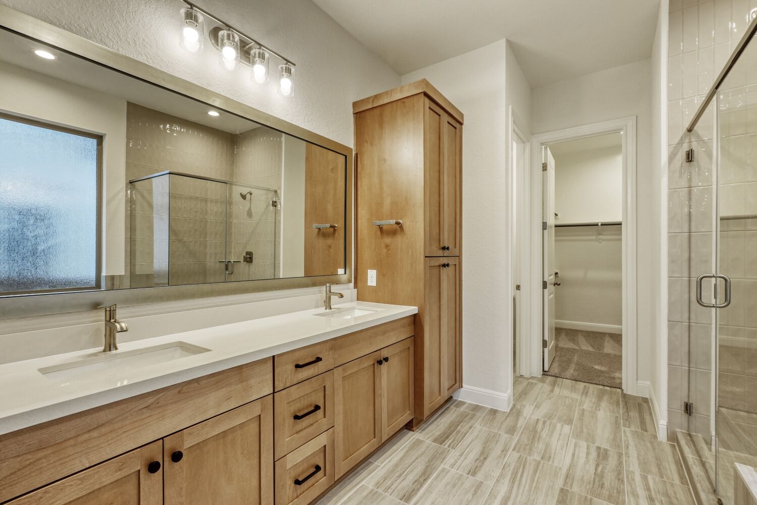 253 Prickly Poppy Loop Kyle, TX 78640 - Photo 8 of 11 a spacious bathroom with a shower sink and mirror