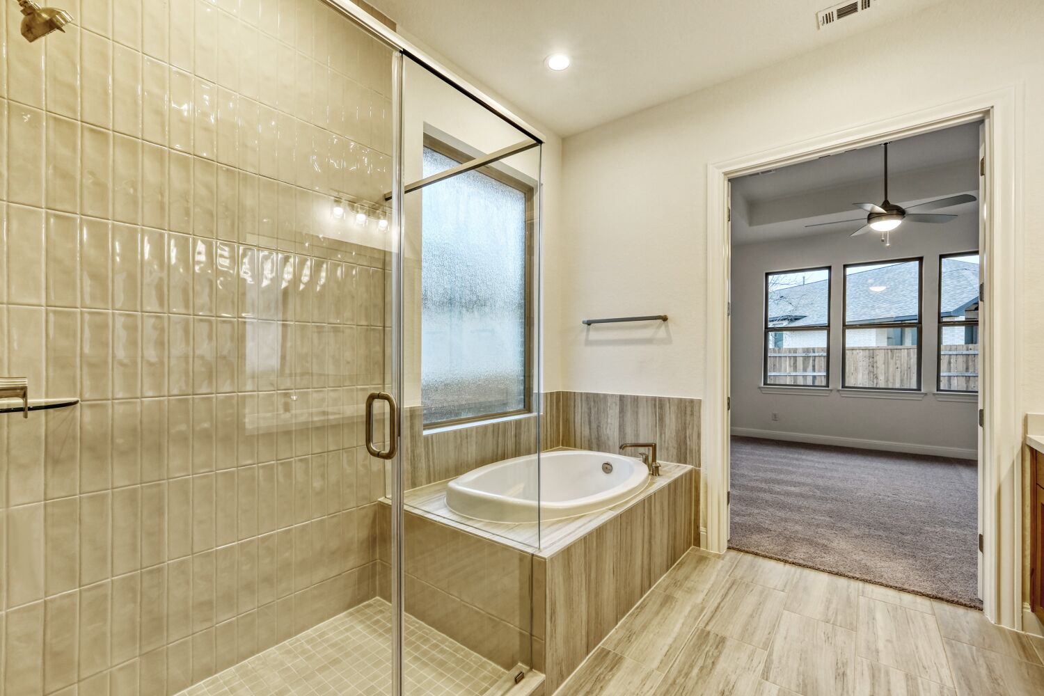 253 Prickly Poppy Loop Kyle, TX 78640 - Photo 9 of 11 a bathroom with a tub a mirror and a shower