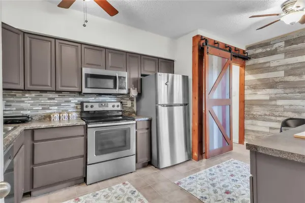 a kitchen with a refrigerator sink and microwave