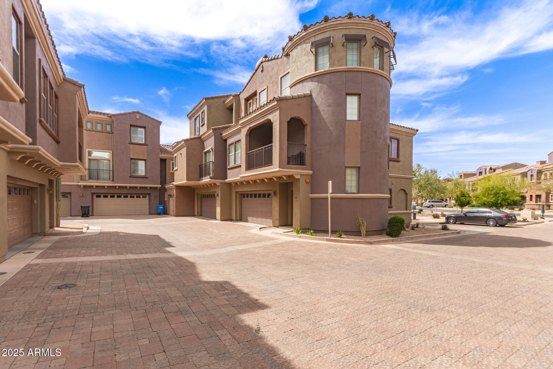 3935 East Rough Rider Road, Unit 1197 Phoenix, AZ 85050 - Photo 1 of 31 a front view of a building with a street