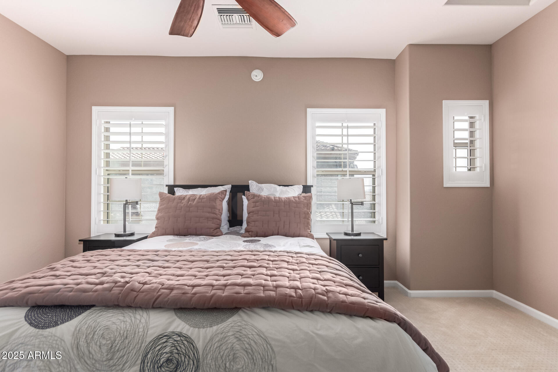 3935 East Rough Rider Road, Unit 1197 Phoenix, AZ 85050 - Photo 14 of 31 a bedroom with a large bed and a window