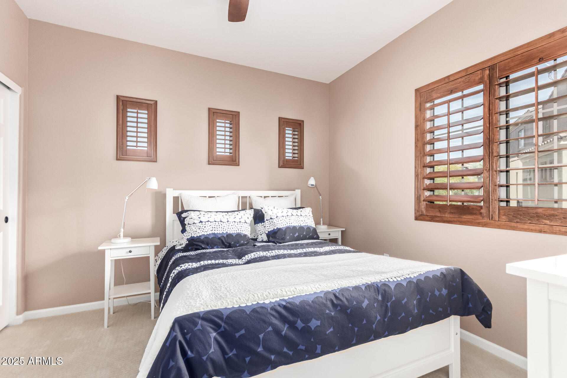 3935 East Rough Rider Road, Unit 1197 Phoenix, AZ 85050 - Photo 19 of 31 a bedroom with a bed and a window
