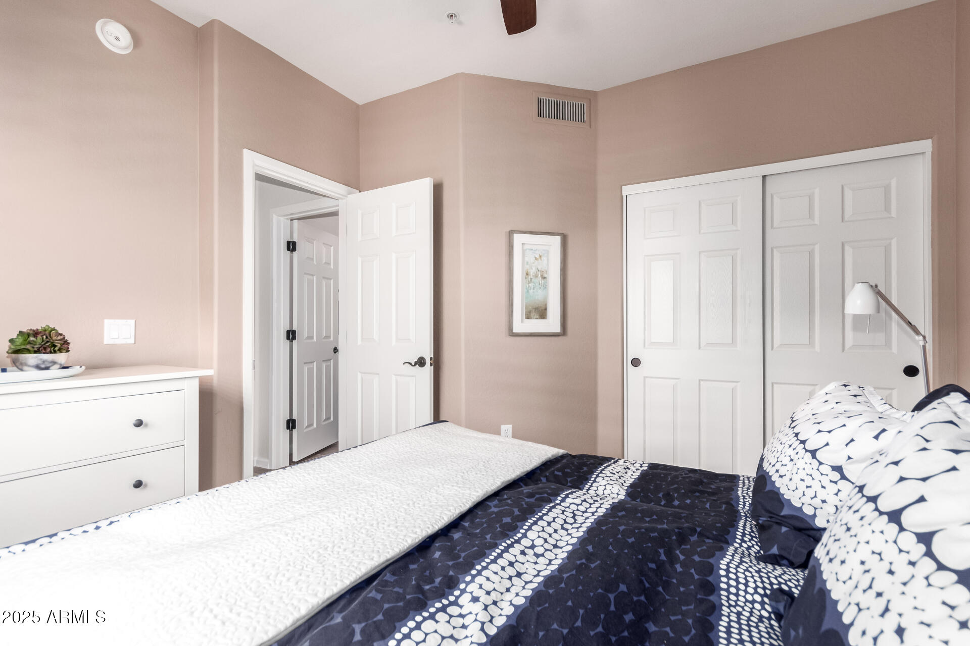 3935 East Rough Rider Road, Unit 1197 Phoenix, AZ 85050 - Photo 20 of 31 a bedroom with a bed and a dresser