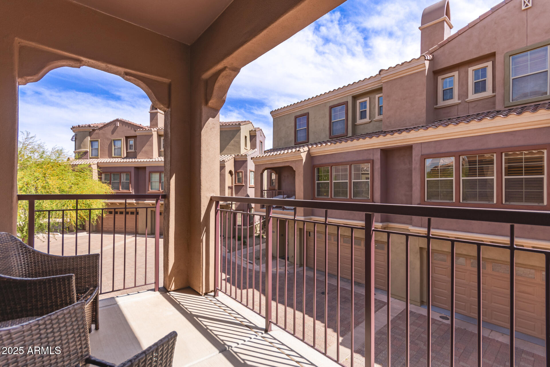 3935 East Rough Rider Road, Unit 1197 Phoenix, AZ 85050 - Photo 25 of 31 a view of a brick house with large windows