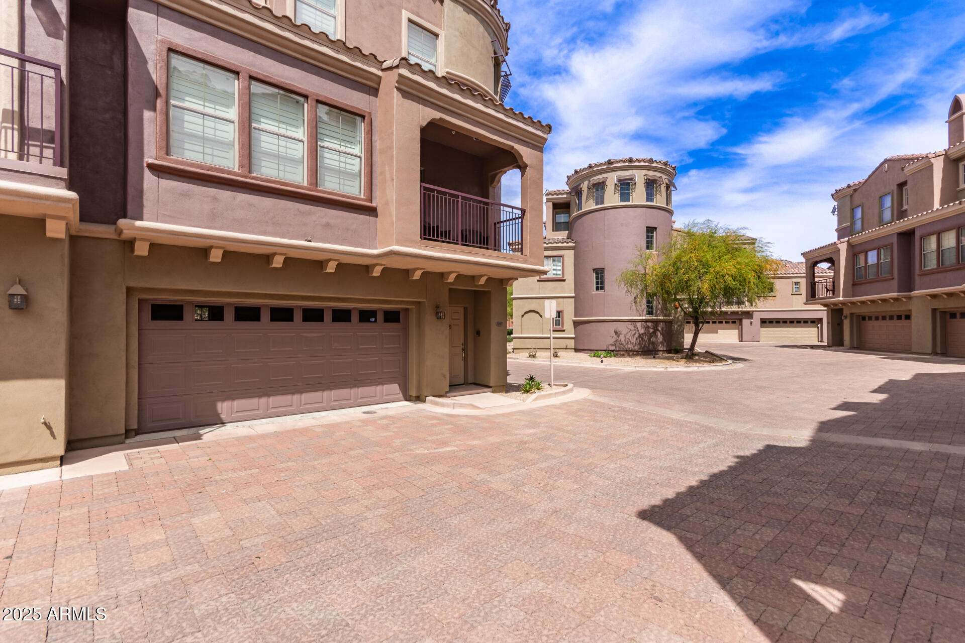 3935 East Rough Rider Road, Unit 1197 Phoenix, AZ 85050 - Photo 3 of 31 a front view of a building with a road