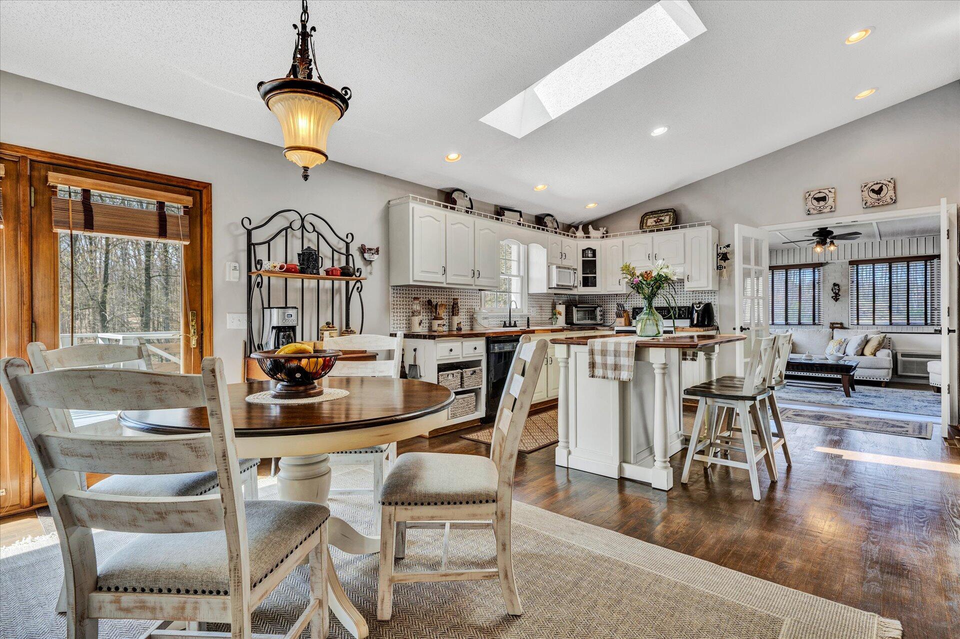 1077 Hopkins Road Rocky Mount, VA 24151 - Photo 14 of 69 a kitchen with stainless steel appliances kitchen island granite countertop a dining table chairs and view living room