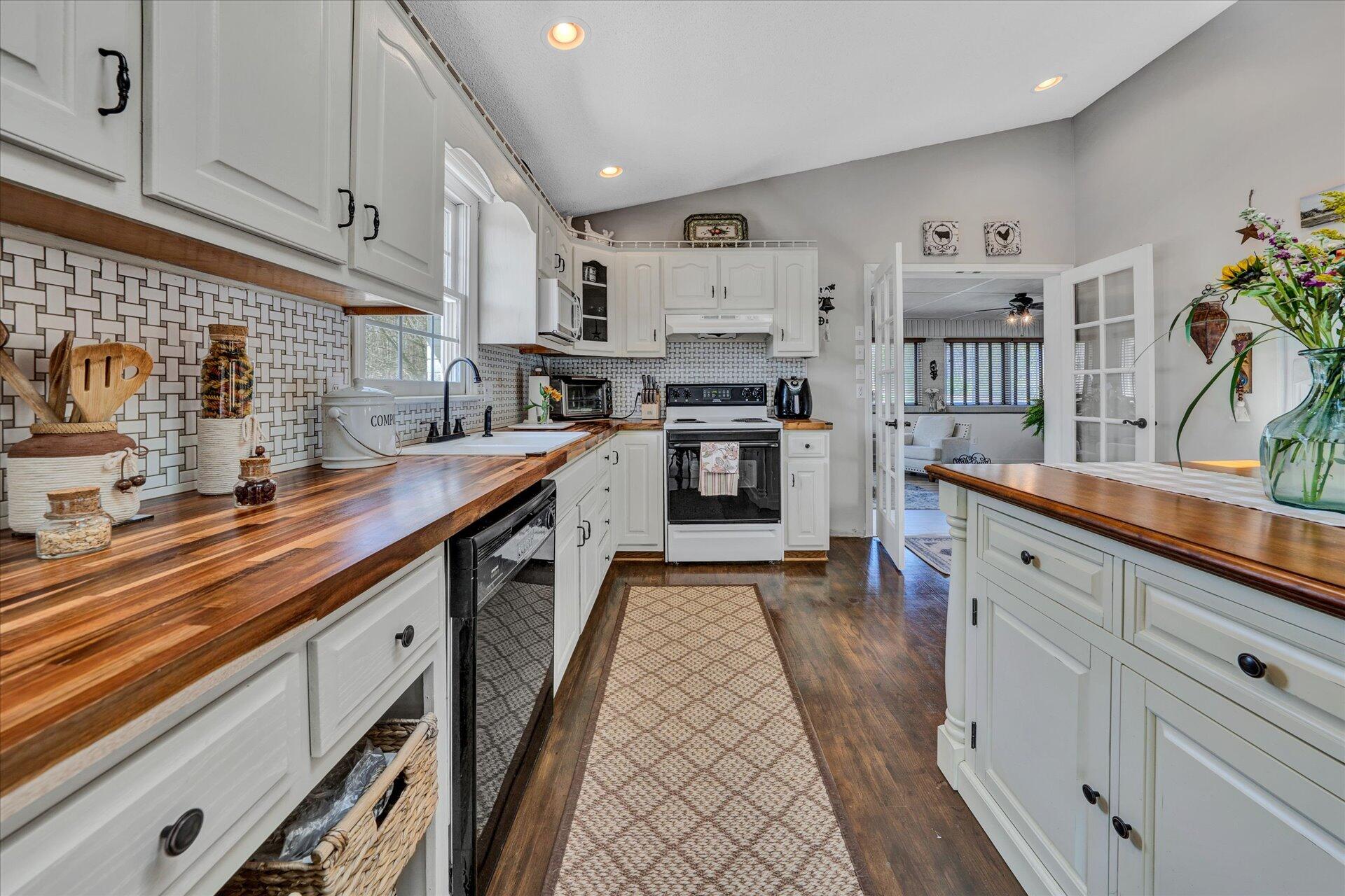 1077 Hopkins Road Rocky Mount, VA 24151 - Photo 17 of 69 a kitchen with stainless steel appliances a sink dishwasher stove refrigerator and cabinets