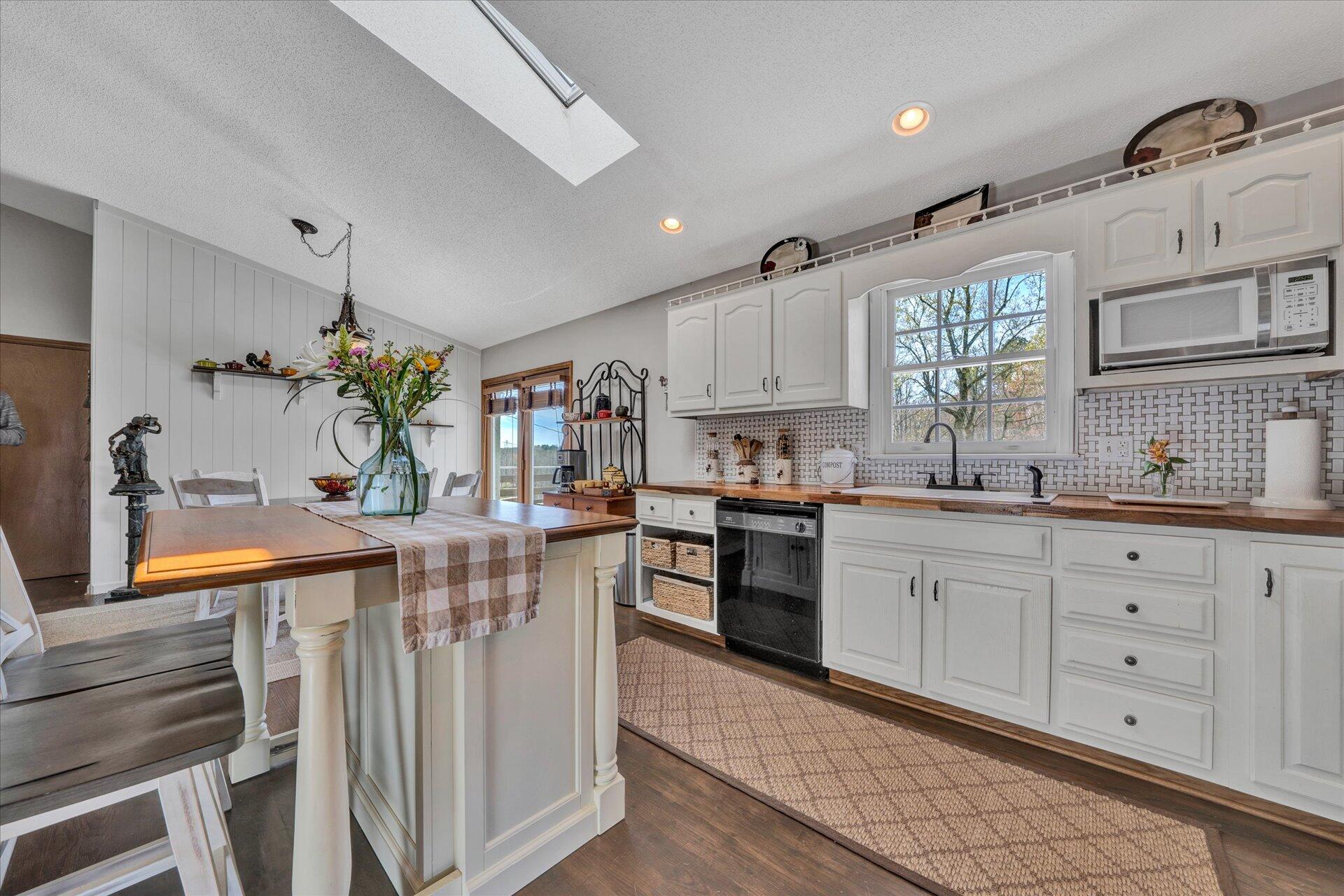 1077 Hopkins Road Rocky Mount, VA 24151 - Photo 22 of 69 a kitchen with white cabinets and appliances