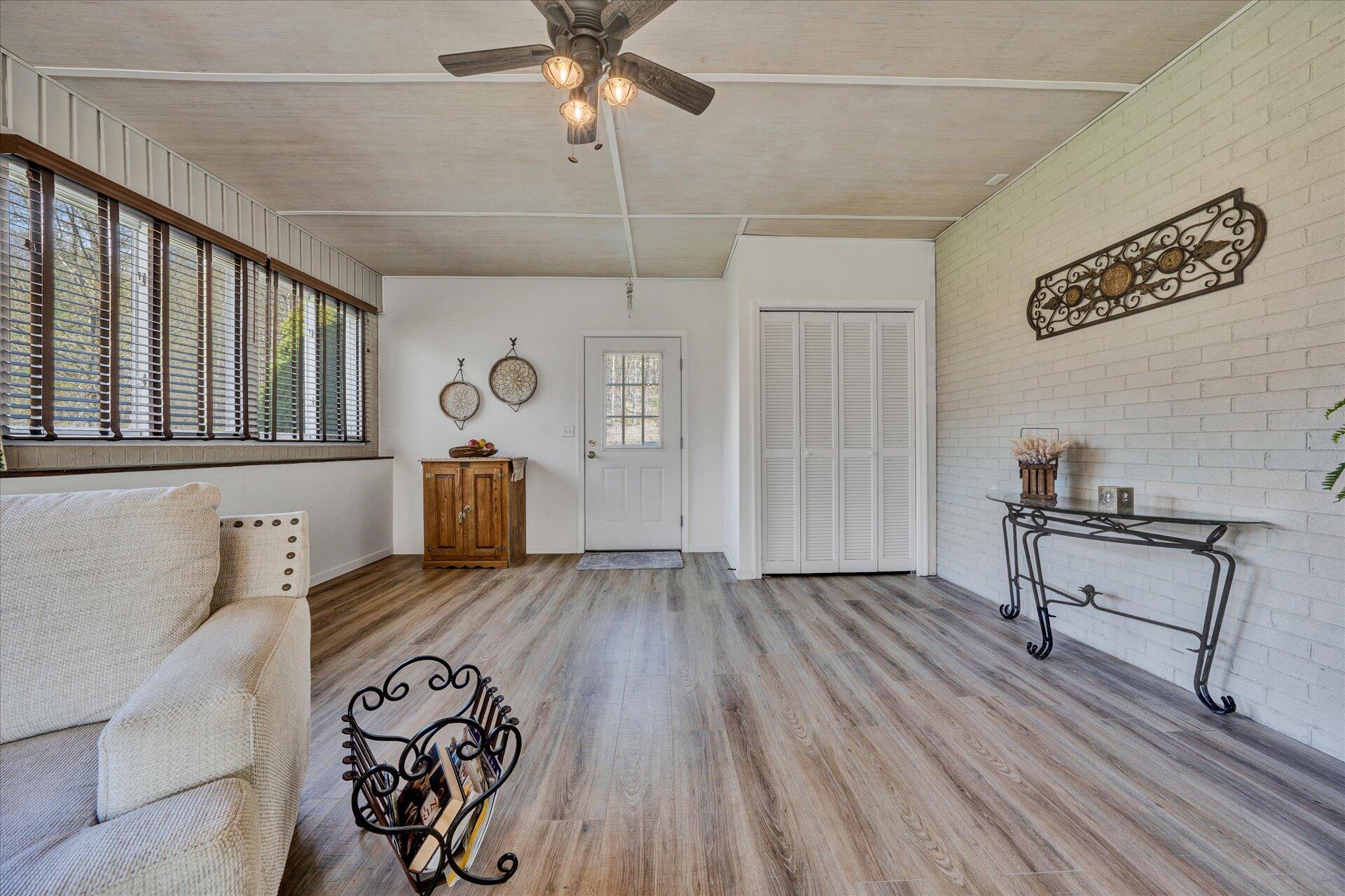1077 Hopkins Road Rocky Mount, VA 24151 - Photo 28 of 69 a view of a livingroom with wooden floor and a ceiling fan