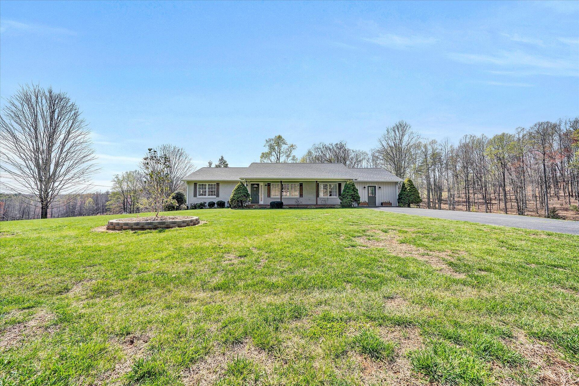 1077 Hopkins Road Rocky Mount, VA 24151 - Photo 53 of 69 a front view of house with yard and trees in the background