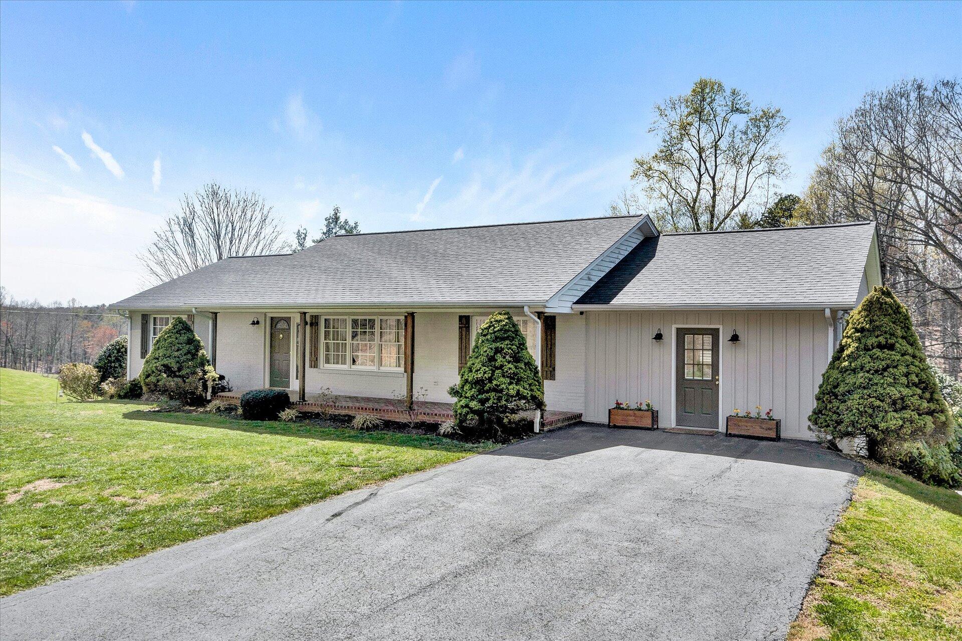 1077 Hopkins Road Rocky Mount, VA 24151 - Photo 67 of 69 a front view of a house with a yard and garage