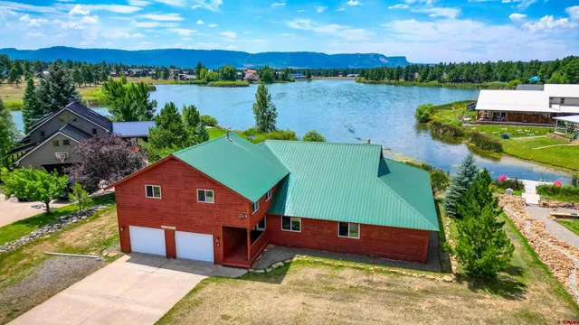 an aerial view of a house with a lake view