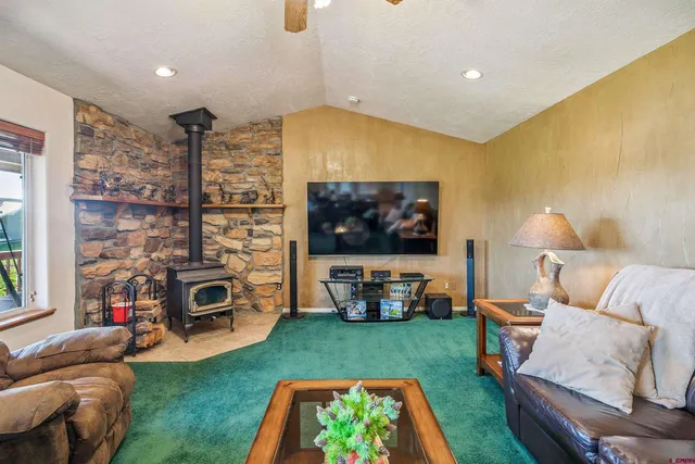 a bedroom with a bed and a large window with outer view