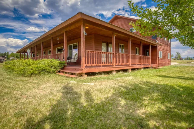 a living room with furniture chandelier and a large window