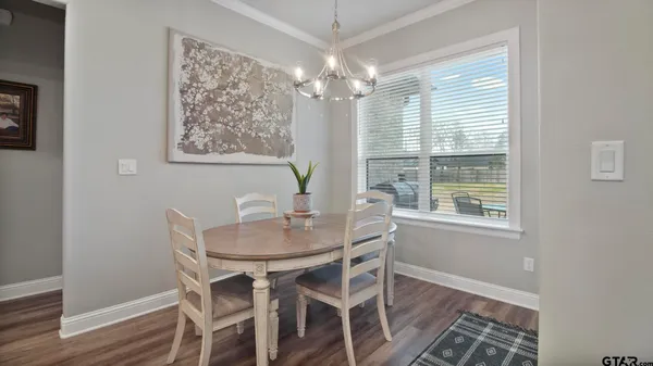 a kitchen with stainless steel appliances granite countertop workspace living room and couches with wooden floor