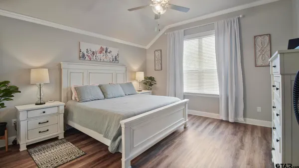 a bedroom with a bed a table and chair