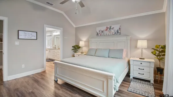 a bathroom with a granite countertop toilet sink and mirror