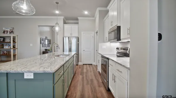 a spacious bathroom with a granite countertop sink a toilet a mirror and shower