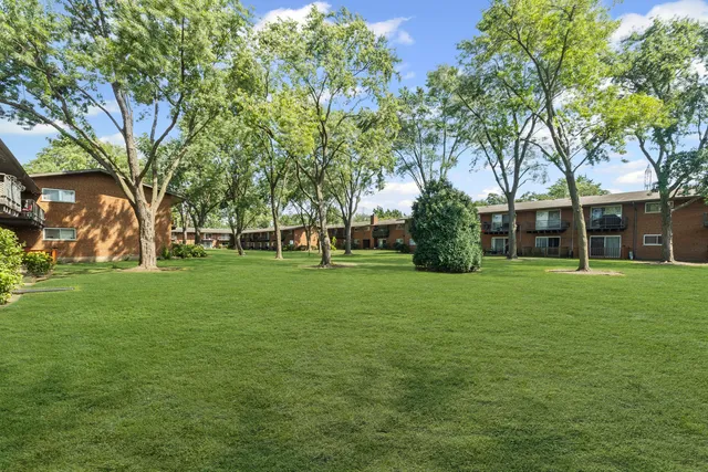 a view of a house with a backyard and a patio