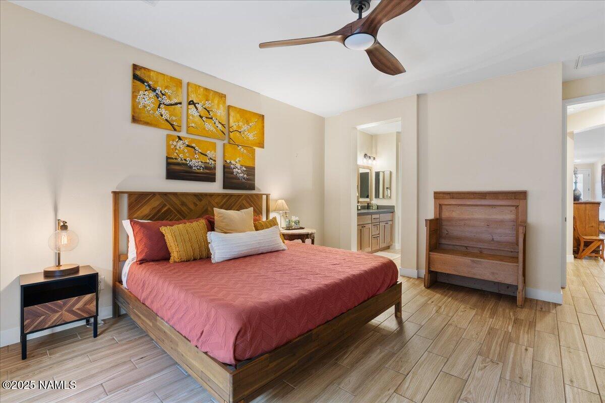 524 Powder Box Road Clarkdale, AZ 86324 - Photo 14 of 32 a bedroom with a bed and wooden floor