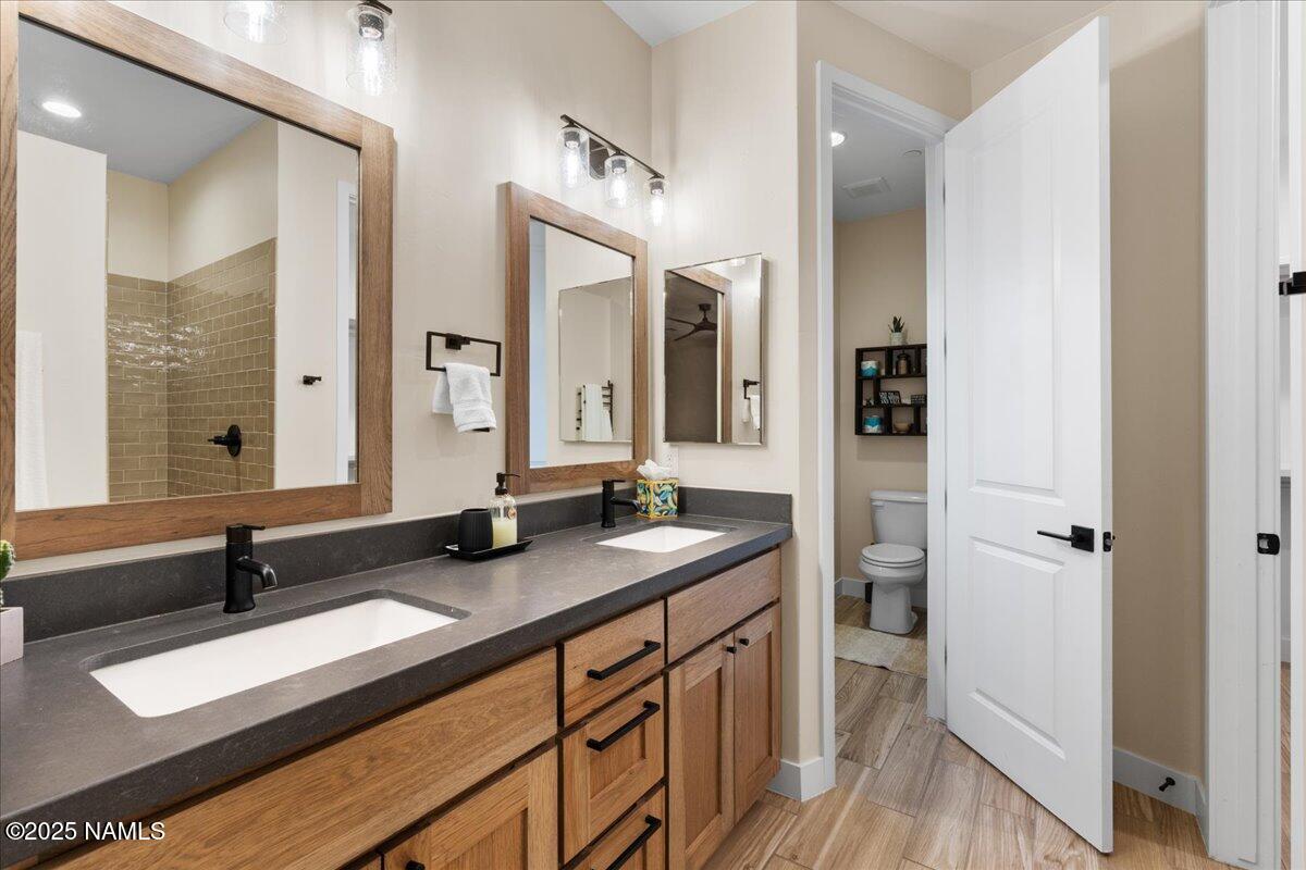 524 Powder Box Road Clarkdale, AZ 86324 - Photo 15 of 32 a bathroom with a granite countertop sink and a mirror