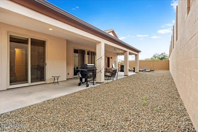 a view of a terrace with a table and chairs