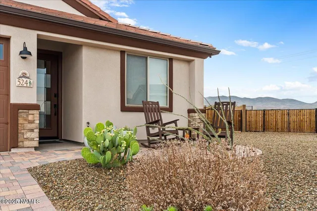 a view of a house with backyard and sitting area