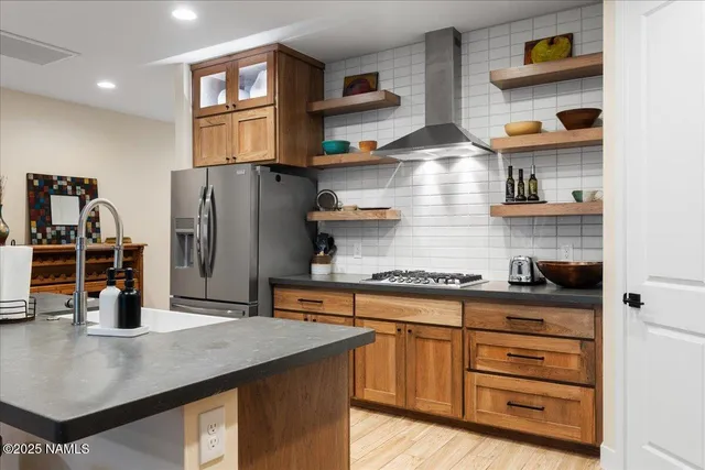 a kitchen with stainless steel appliances granite countertop a sink and wooden cabinets