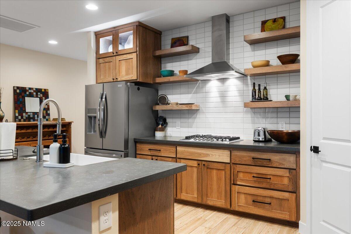 524 Powder Box Road Clarkdale, AZ 86324 - Photo 9 of 32 a kitchen with stainless steel appliances granite countertop a sink and wooden cabinets