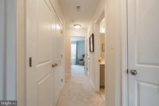 a view of a hallway with wooden shelves
