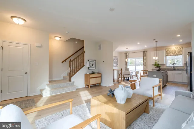 a living room with furniture and kitchen view