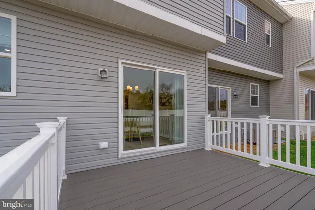 a view of a brick house with a deck