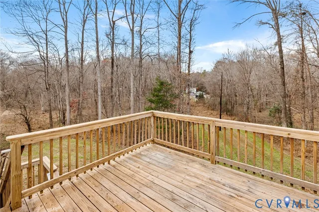 a view of balcony with wooden floor and fence
