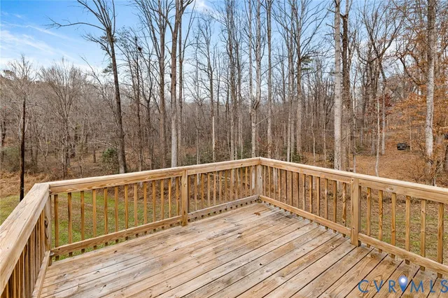 a balcony with wooden floor and fence