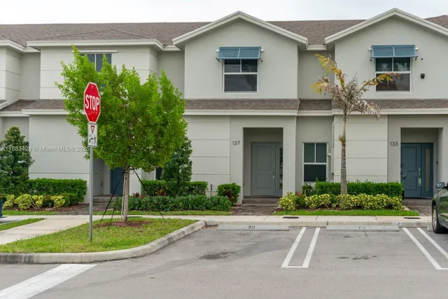 a front view of a house with a yard and a garage