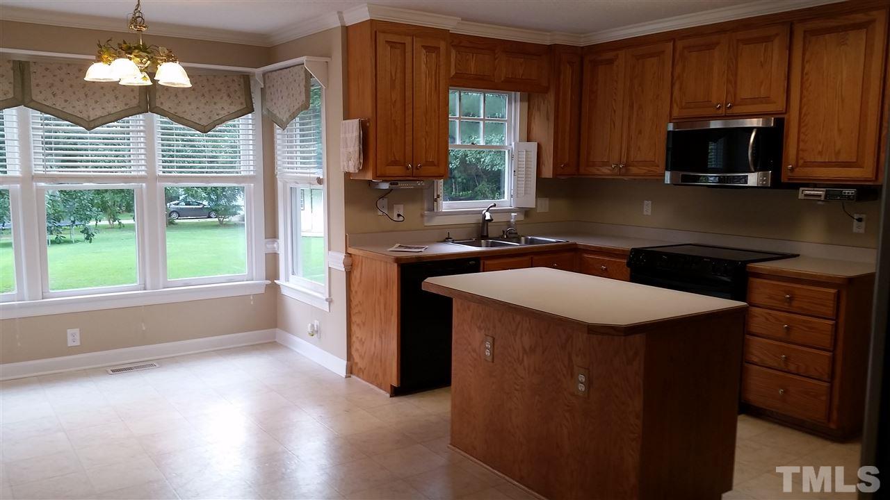 901 Lendermans Circle Raleigh, NC 27603 - Photo 8 of 25 a kitchen with a sink stove and microwave