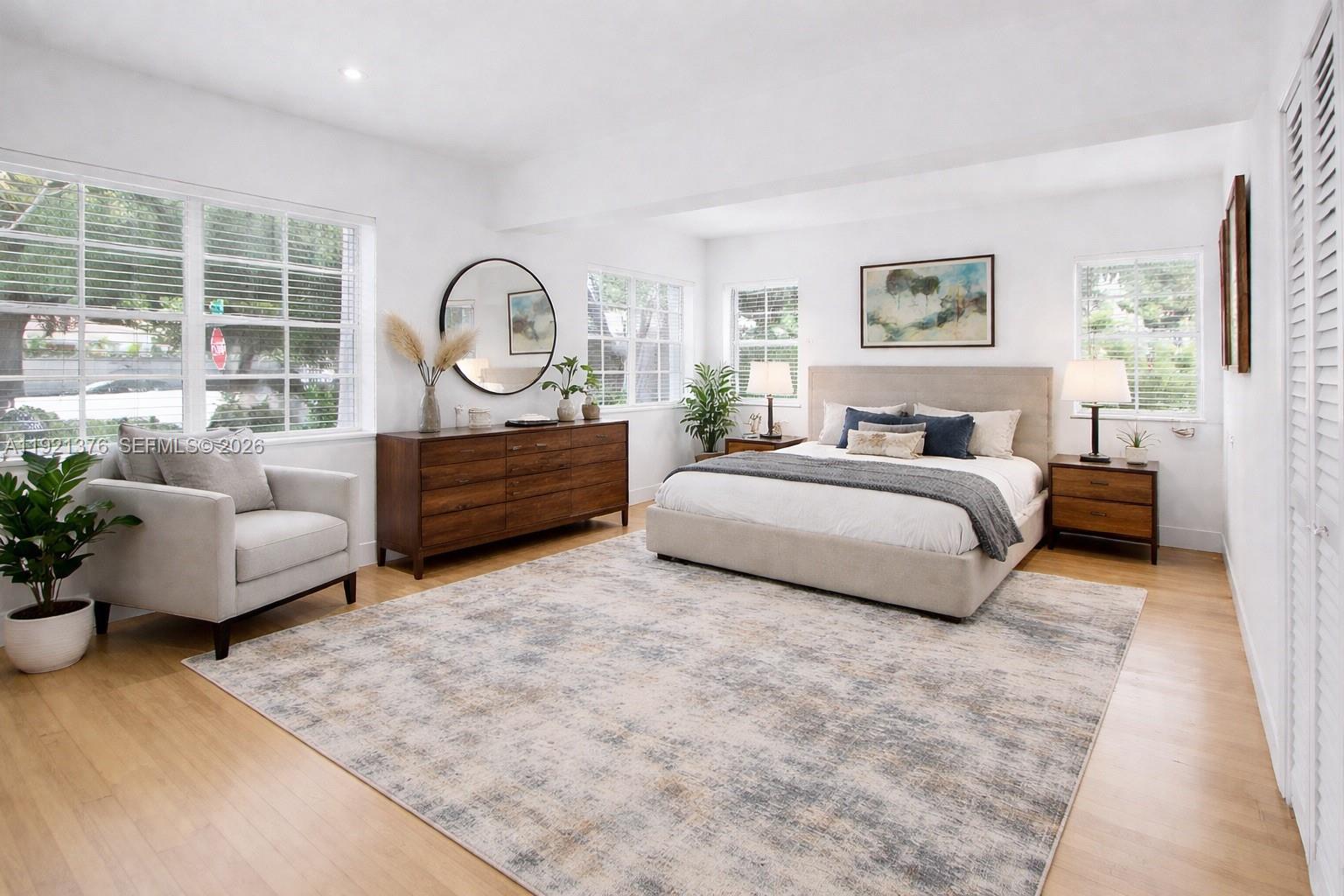 100 Southwest 30th Road Miami, FL 33129 - Photo 16 of 31 a spacious bedroom with a bed a couch and a window