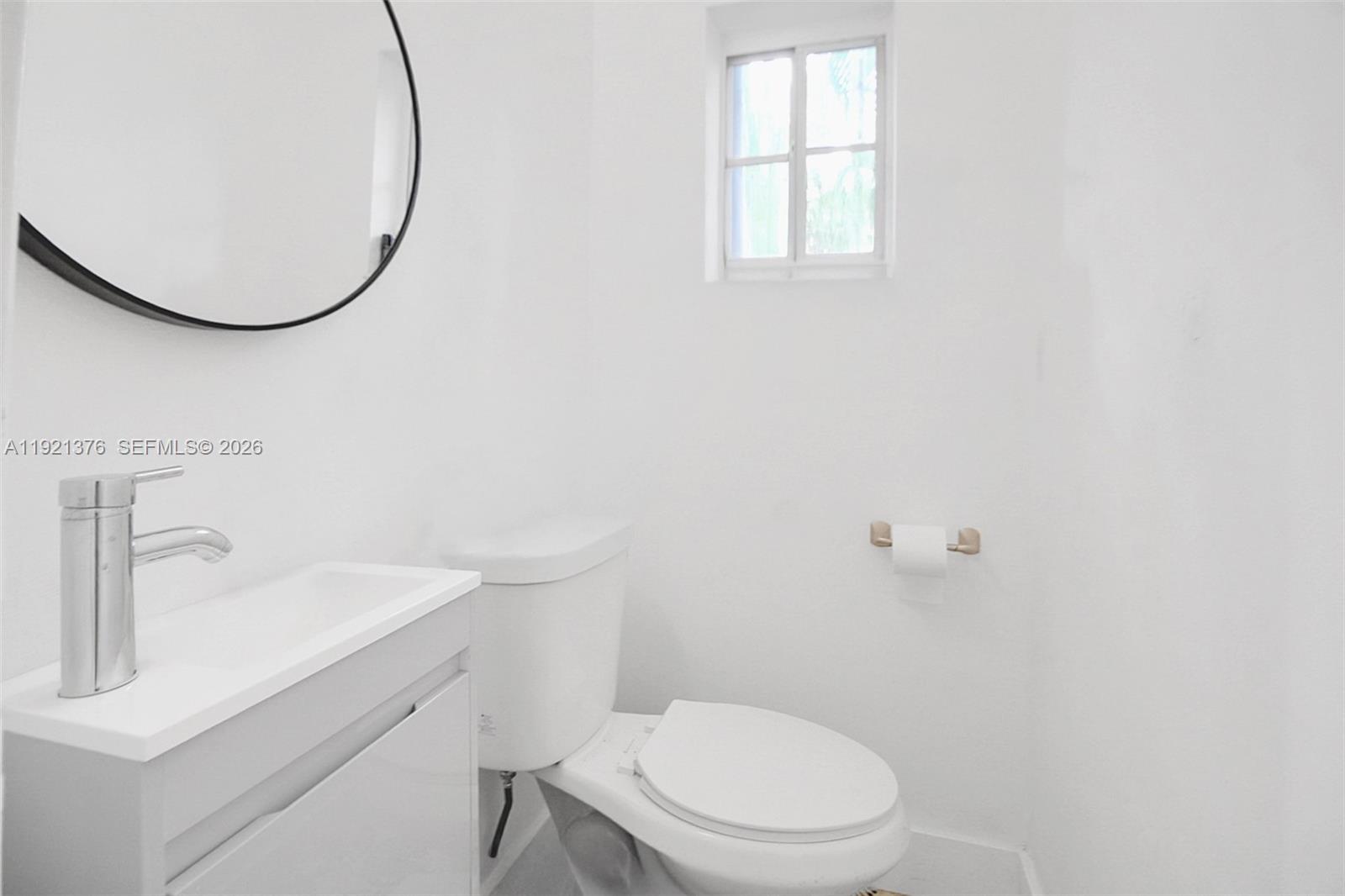 100 Southwest 30th Road Miami, FL 33129 - Photo 19 of 31 a white toilet sitting next to a bathroom sink