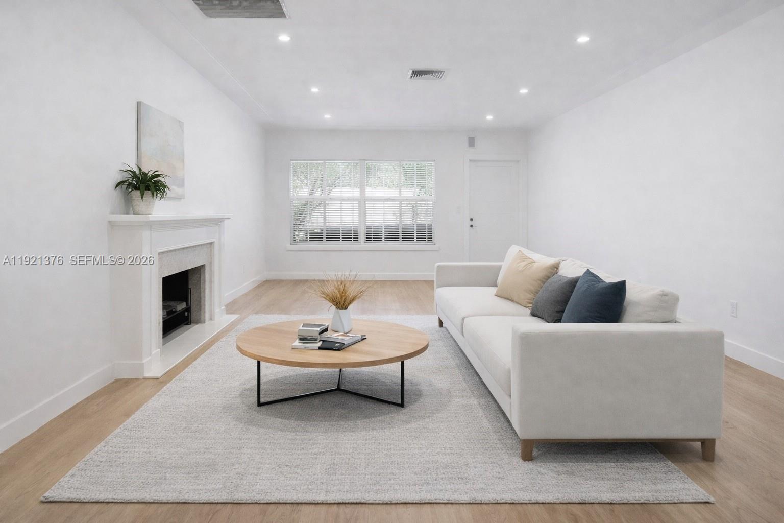 100 Southwest 30th Road Miami, FL 33129 - Photo 5 of 31 a living room with furniture and a fireplace