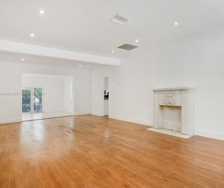 100 Southwest 30th Road Miami, FL 33129 - Photo 10 of 31 a view of an empty room with wooden floor and a window