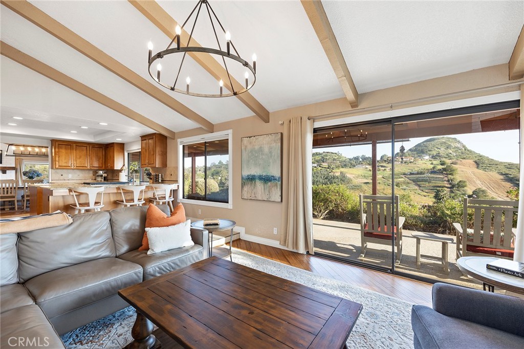 4613 Sleeping Indian Road Fallbrook, CA 92028 - Photo 12 of 75 a living room with furniture a wooden floor and a large window