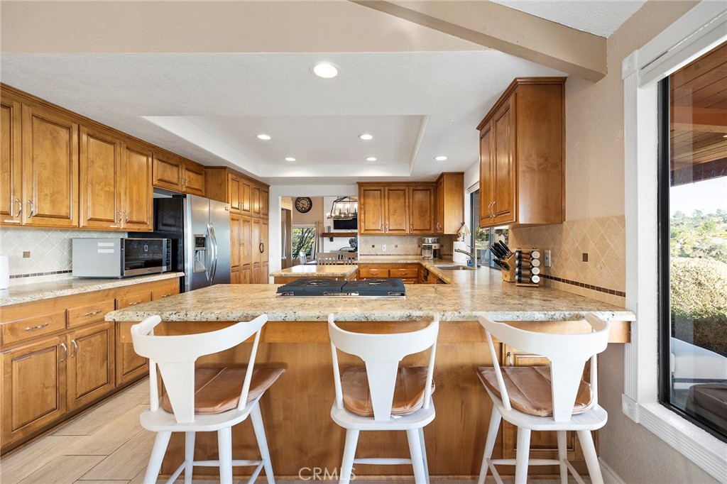 4613 Sleeping Indian Road Fallbrook, CA 92028 - Photo 15 of 75 a kitchen with stainless steel appliances kitchen island granite countertop a sink and cabinets