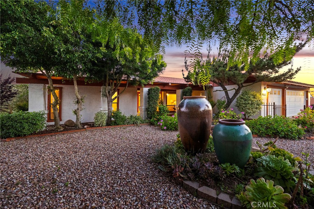 4613 Sleeping Indian Road Fallbrook, CA 92028 - Photo 2 of 75 a view of a backyard with plants and a large tree