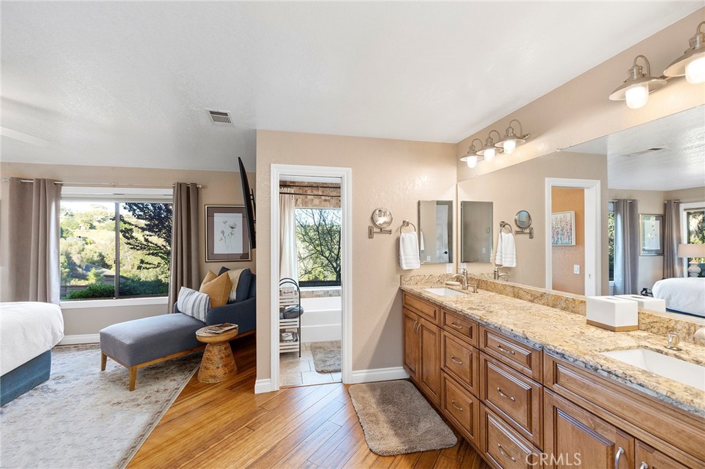4613 Sleeping Indian Road Fallbrook, CA 92028 - Photo 23 of 75 a large living room with stainless steel appliances granite countertop a couch and a large window with wooden floor