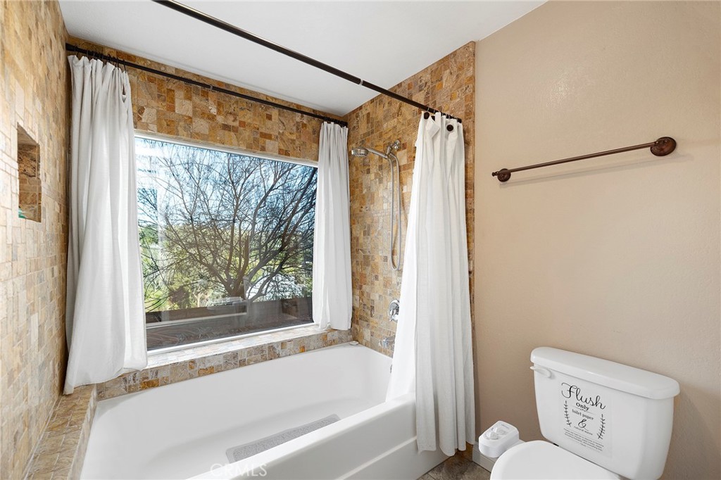 4613 Sleeping Indian Road Fallbrook, CA 92028 - Photo 31 of 75 a bathroom with a shower and a bathtub