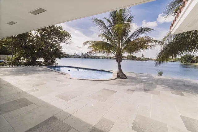 a view of a patio with table and chairs with wooden fence and plants