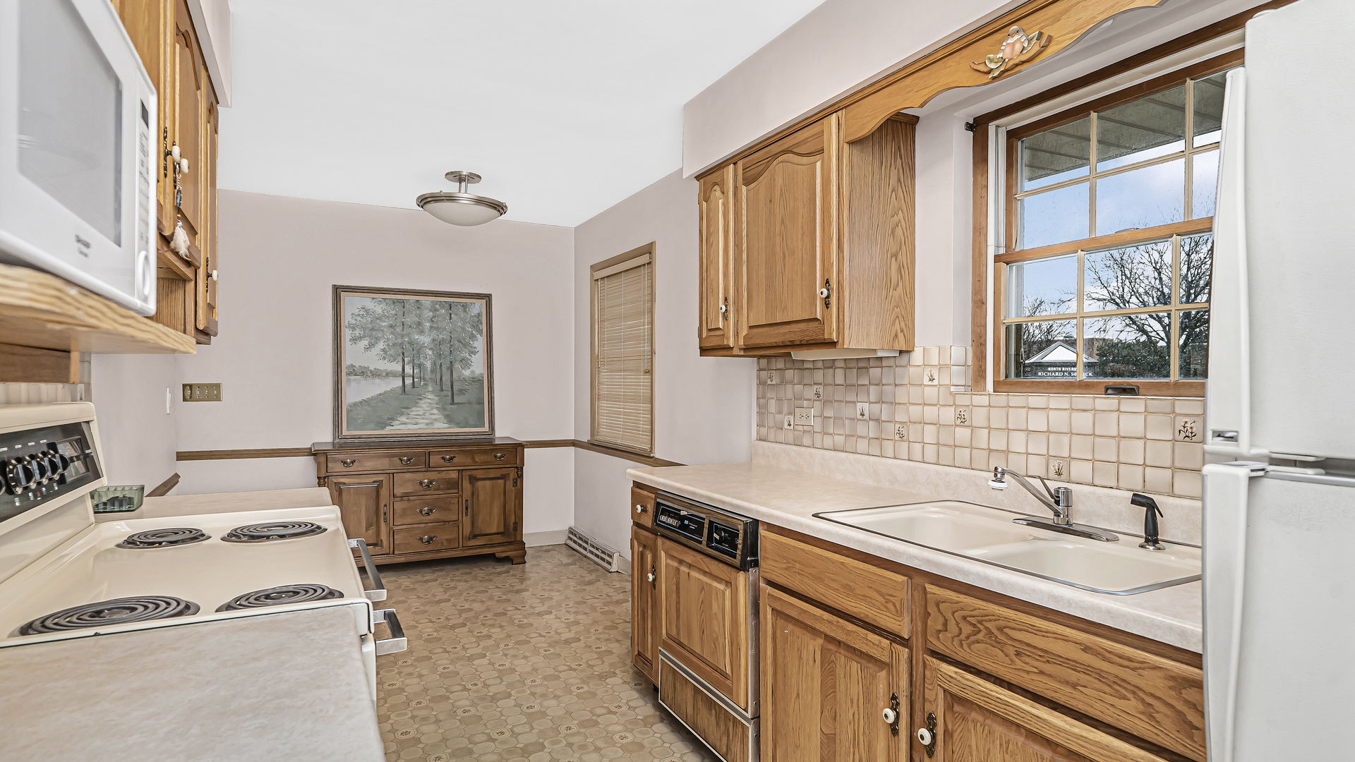 8000 Country Club Lane North Riverside, IL 60546 - Photo 5 of 19 a kitchen that has a sink a stove and a microwave oven