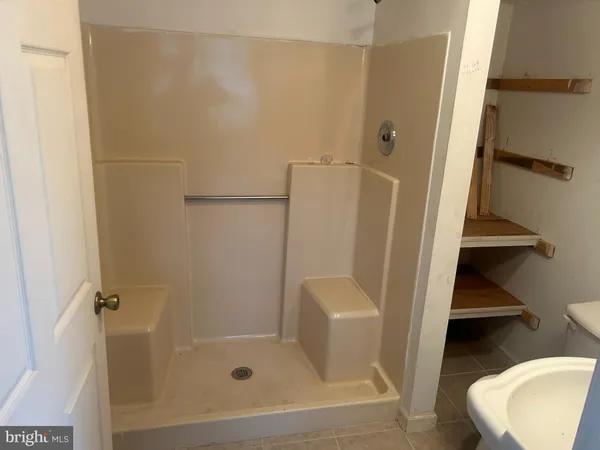 a storage room with water heater and racks