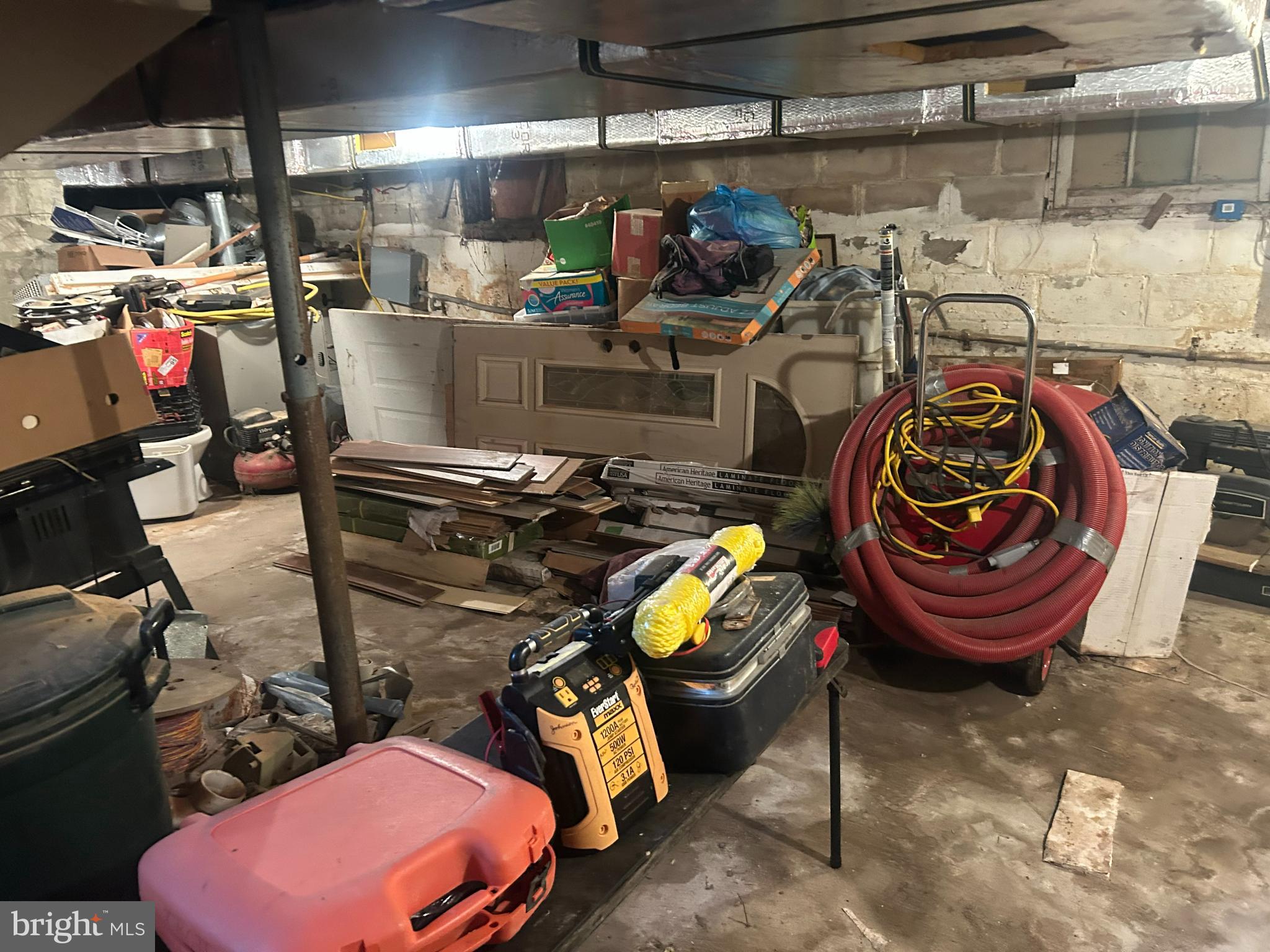 313 Penn Street Salisbury, MD 21801 - Photo 20 of 40 a view of a storage room with water heater and racks